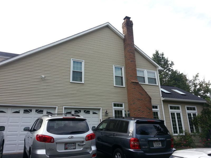 a house with two cars parked in front of it