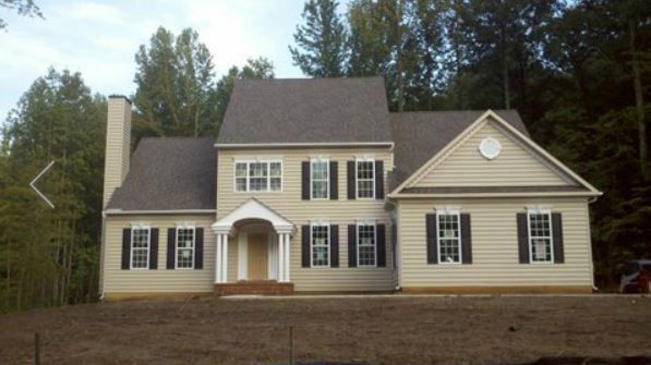 a large house with a lot of windows and shutters