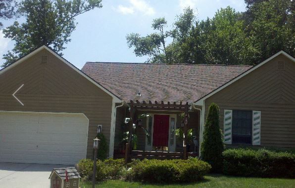 a house with a red door and a white garage door