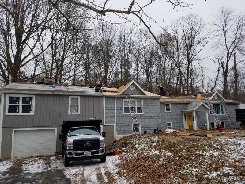 a truck is parked in front of a house that is being remodeled .