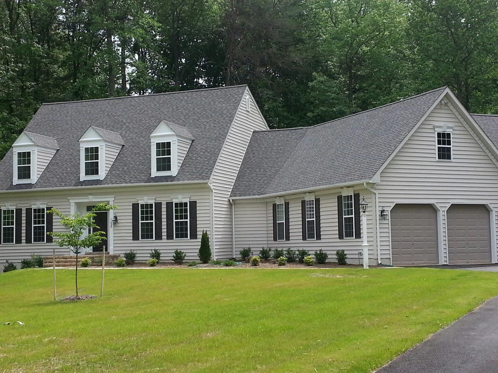 a large white house with a gray roof