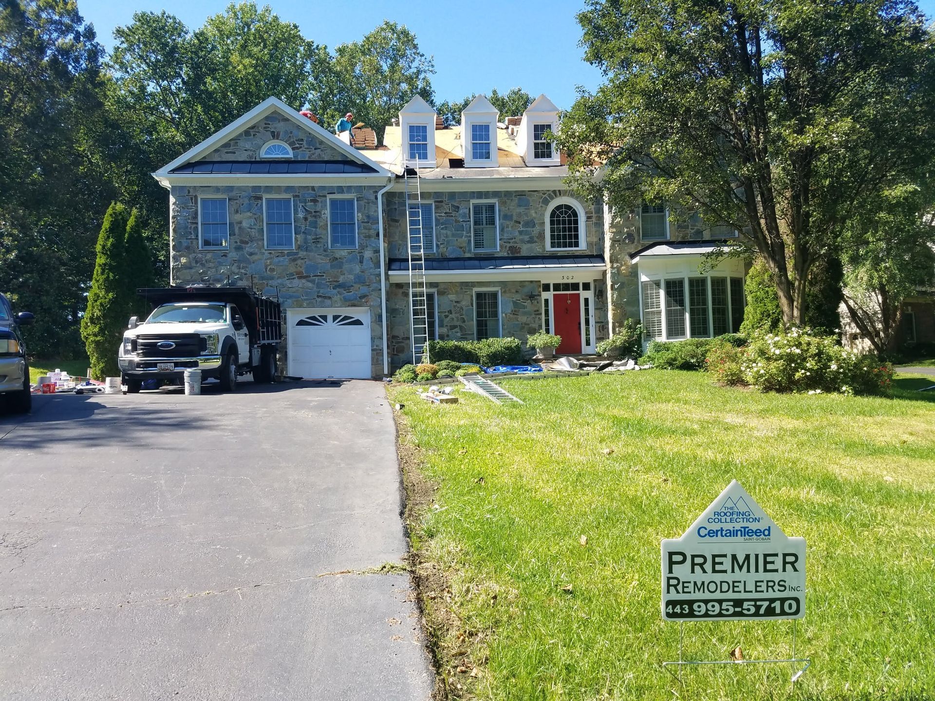 A large house with a truck parked in front of it