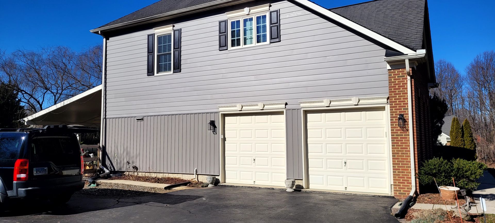 a white and gray house with a gray roof