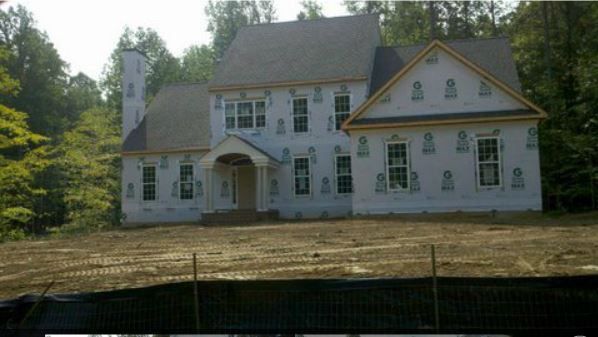 a large white house is being built in the woods