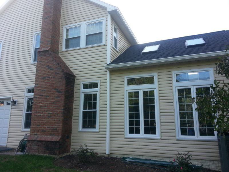 a house with a brick chimney and lots of windows