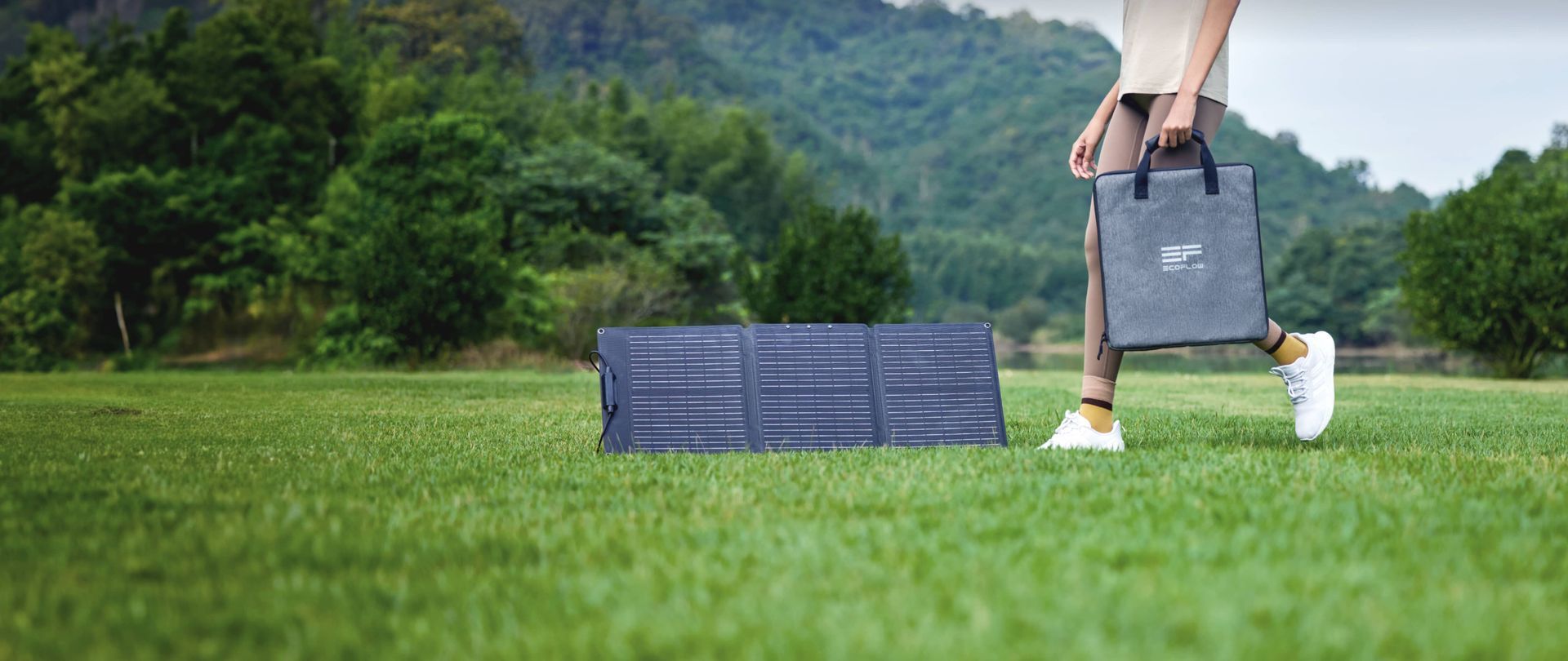 A folded, dark gray solar panel set up outdoors.