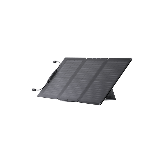 A folded, dark gray solar panel set up outdoors.