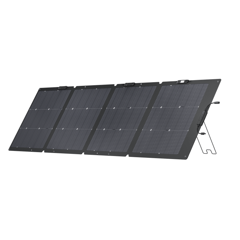 Foldable black solar panel with supporting stand, outdoors.