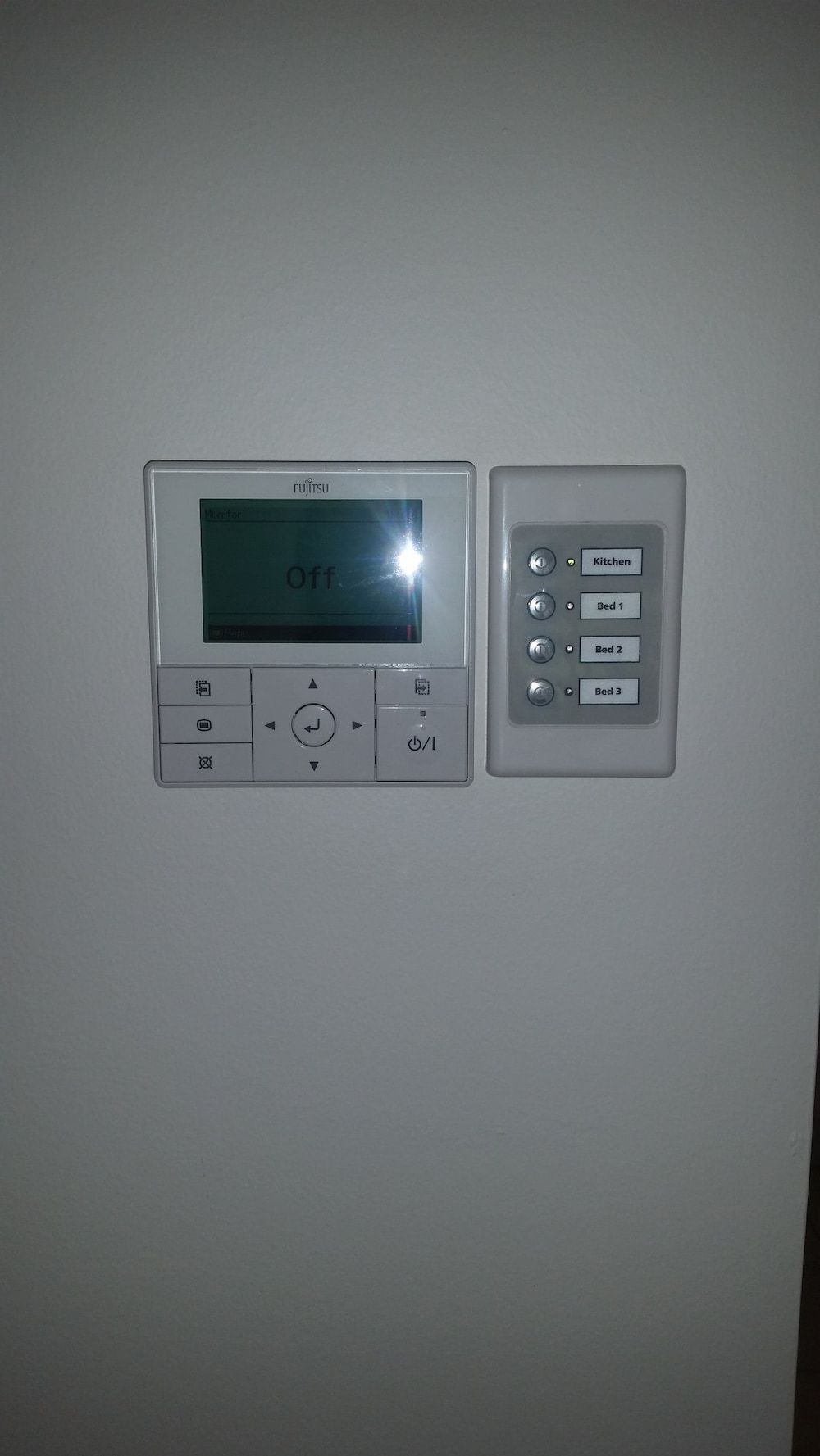 a Thermostat is Hanging on a Wall Next to a Control Panel — D.J. Whatley & Son Pty Ltd in Yatala, QLD
