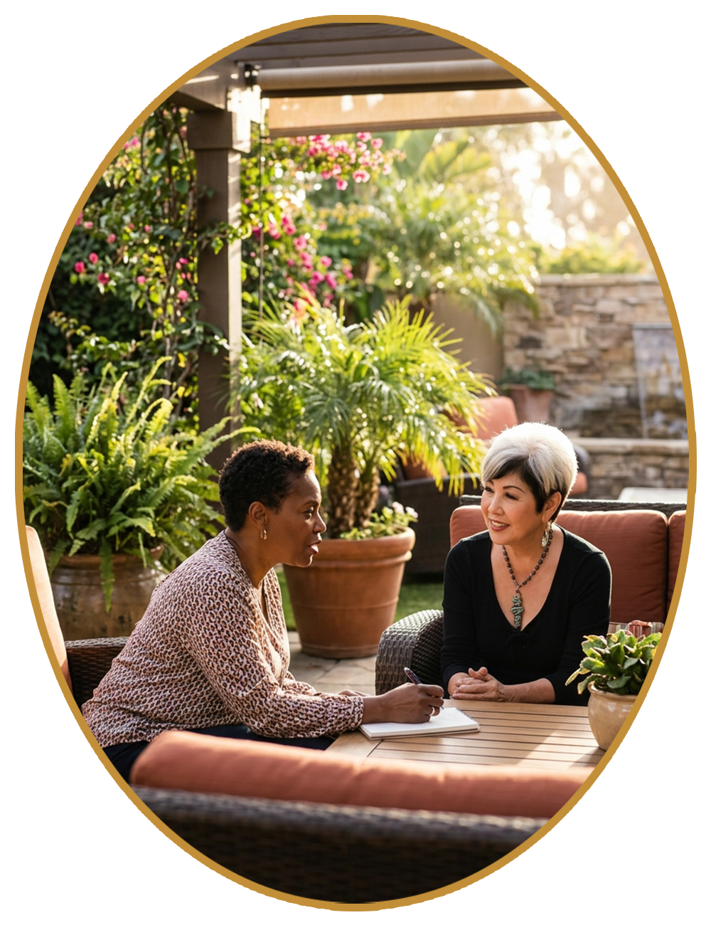 Two people chatting at an outdoor café table in a lush garden patio.