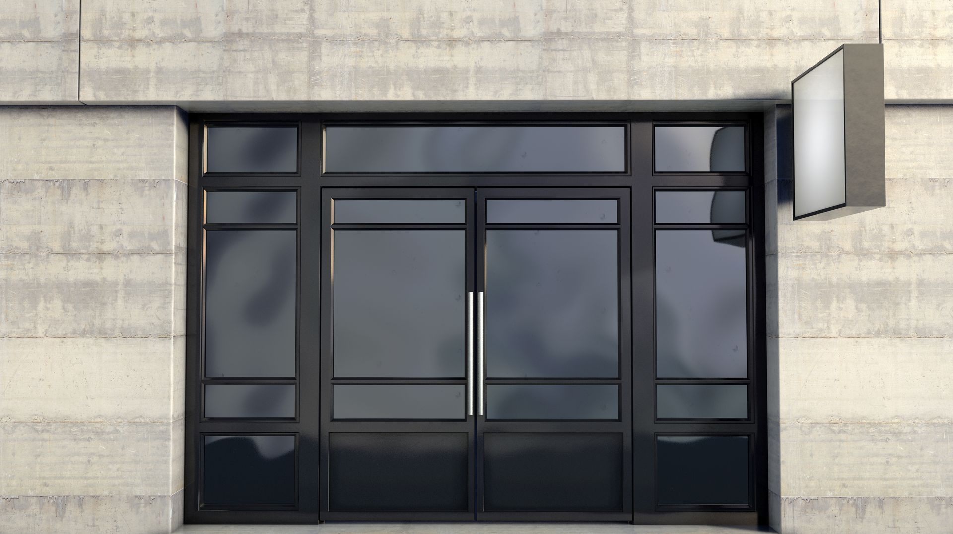 Modern building entrance with large glass doors and an illuminated sign.