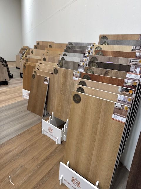 Wooden display panels with metal sample sheets arranged in a showroom or office setting