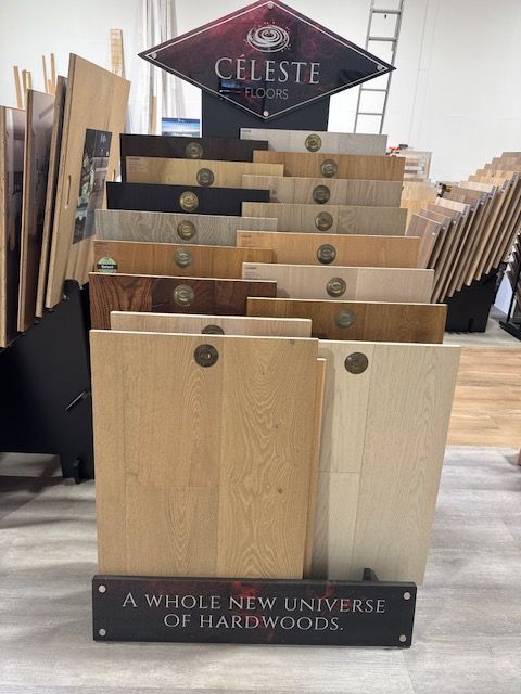 Display rack of hardwood samples with a Celeste sign and “A whole new universe of hardwoods” at bottom