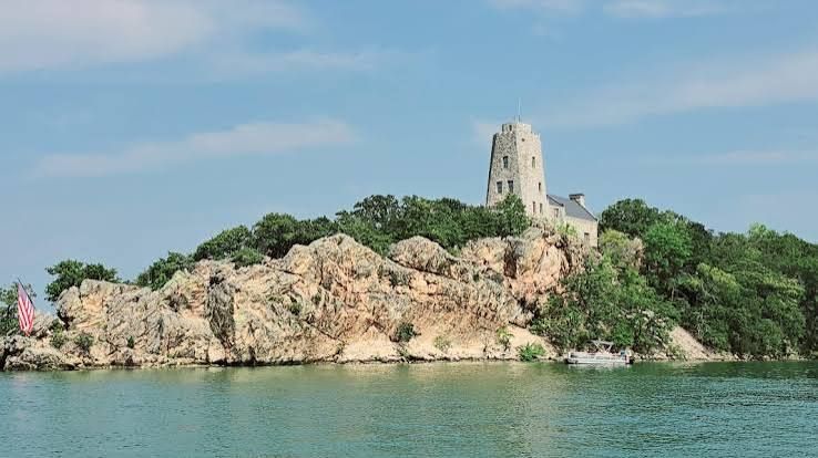 Tucker Tower at Lake Murray State Park in Ardmore, Oklahoma near River of Love Cabins featuring panoramic lake views, historic stone architecture, scenic overlooks, and a nature center.