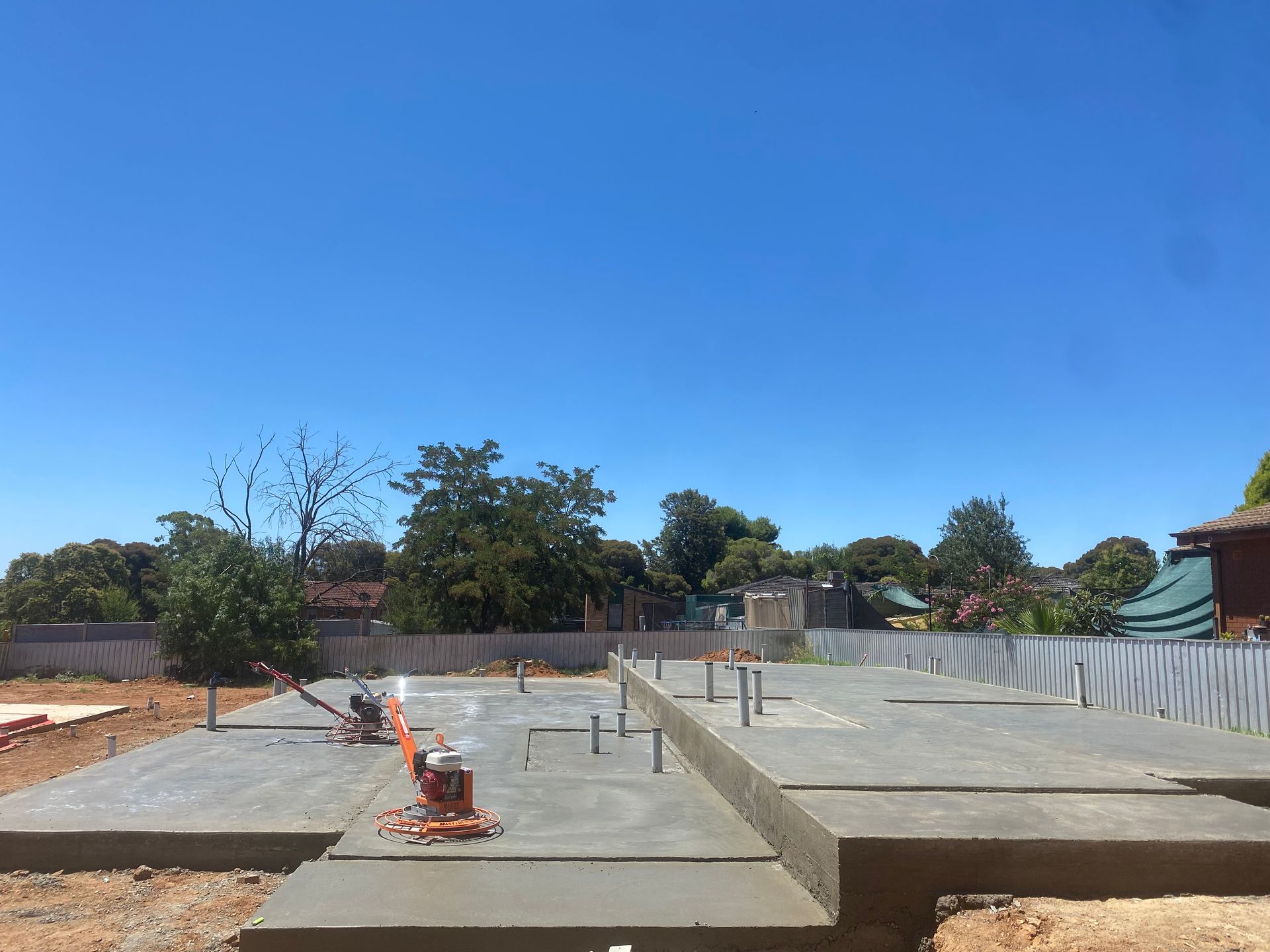 Concrete foundation under construction with rebar, forms, and a clear blue sky — Complete Concreting Riverina In Ashmont, NSW