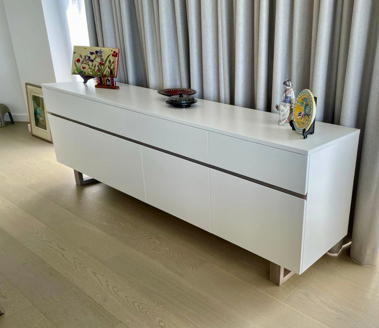 White Modern Credenza With Objects on Top, in Front of a Neutral-toned Curtain — Norrland in Warners Bay, NSW