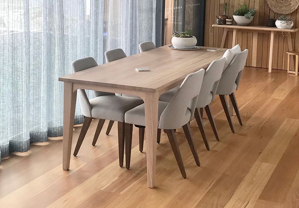 Wooden Dining Table With Eight Light Gray Chairs in a Bright Room — Norrland in Warners Bay, NSW