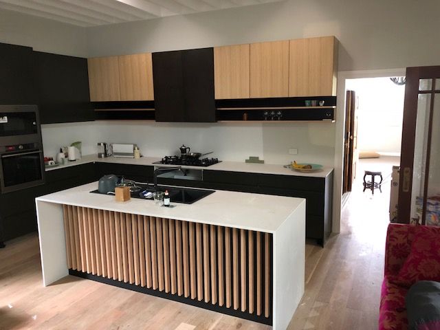 Modern Kitchen With Black and Wood Cabinets, White Countertops, and Wood-slat Island — Norrland in Warners Bay, NSW