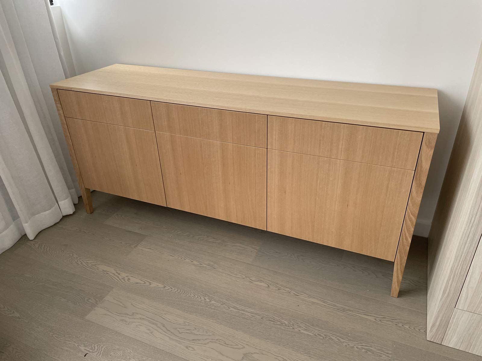Light Wood Cabinet With Three Doors and Angled Legs, Against a White Wall and Floor — Norrland in Warners Bay, NSW