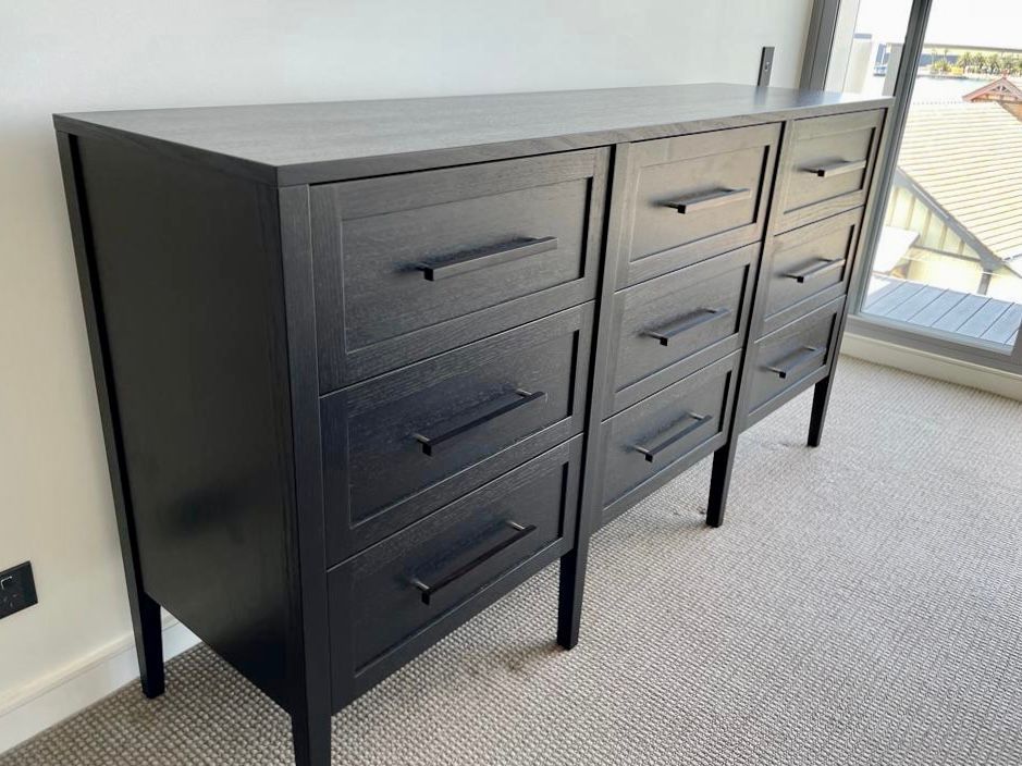 A black dresser with three large left drawers and three smaller right drawers — Norrland in Warners Bay, NSW