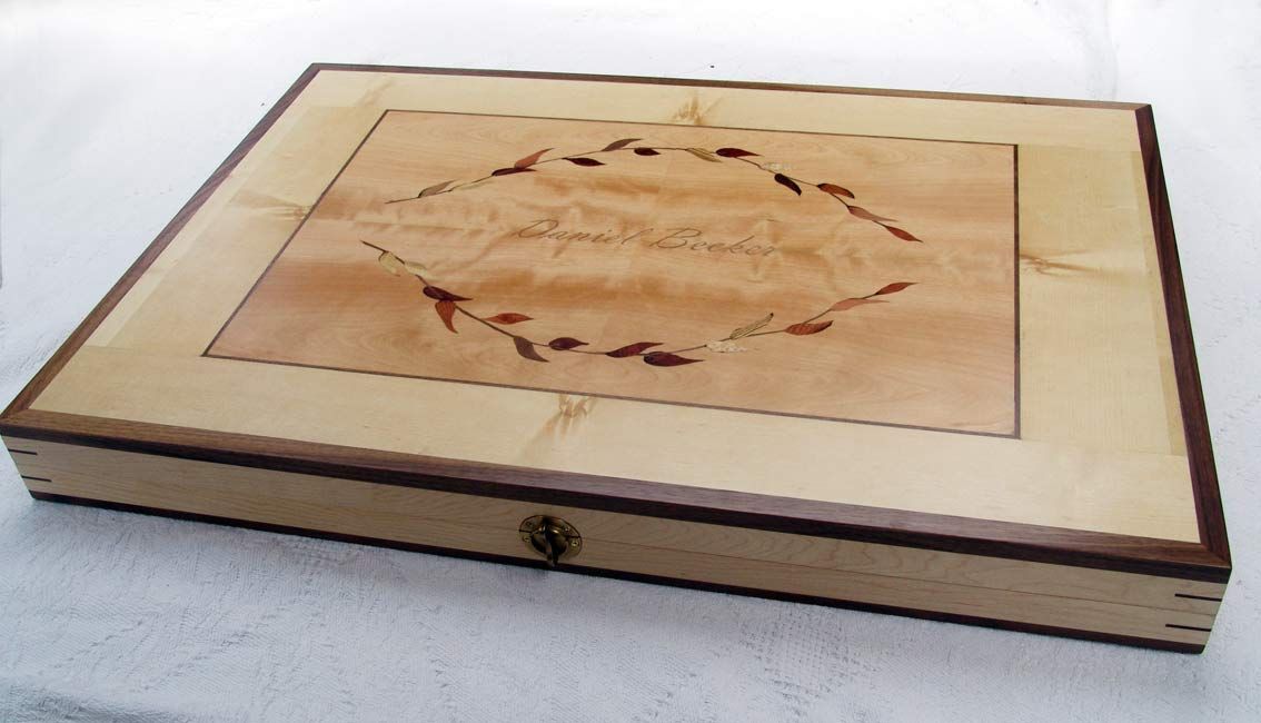 Wooden box with inlaid design and lock.