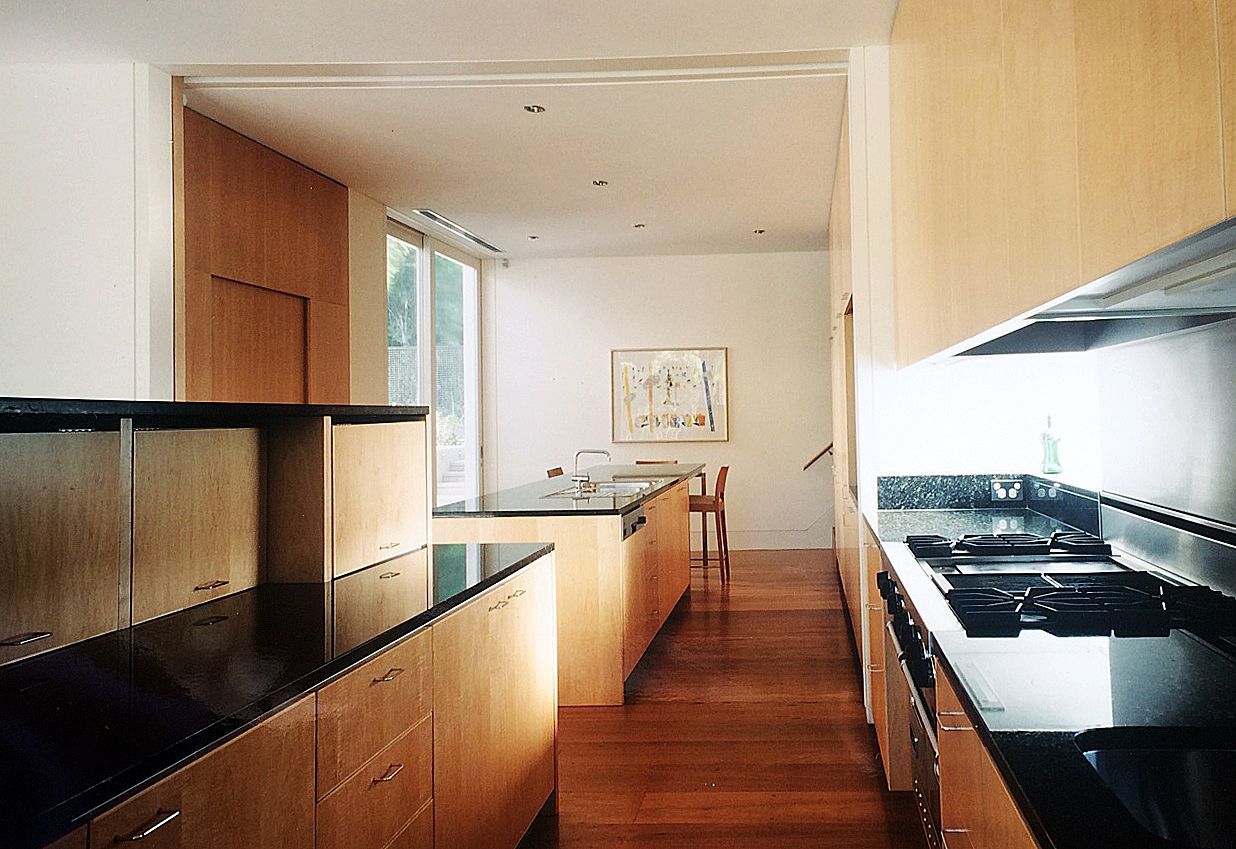 Modern Kitchen With Wooden Cabinets, Black Countertops, and Island — Norrland in Warners Bay, NSW