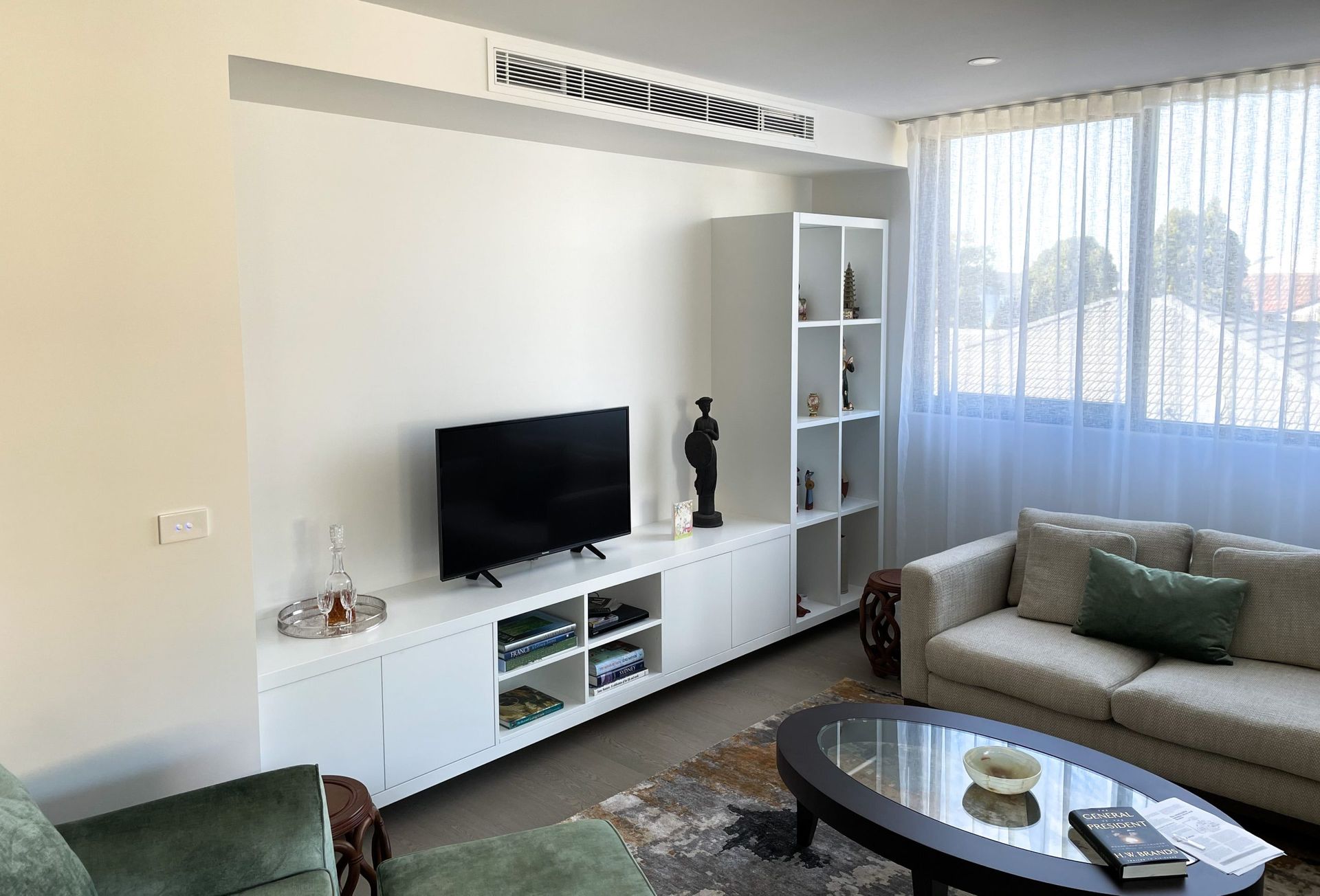 Living Room With White Built-in Entertainment Center, Sofa, Chair, and Coffee Table — Norrland in Warners Bay, NSW