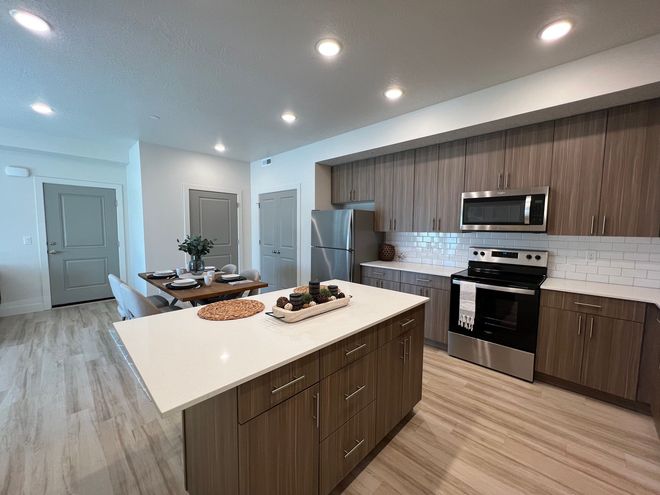 a kitchen with stainless steel appliances and wooden cabinets