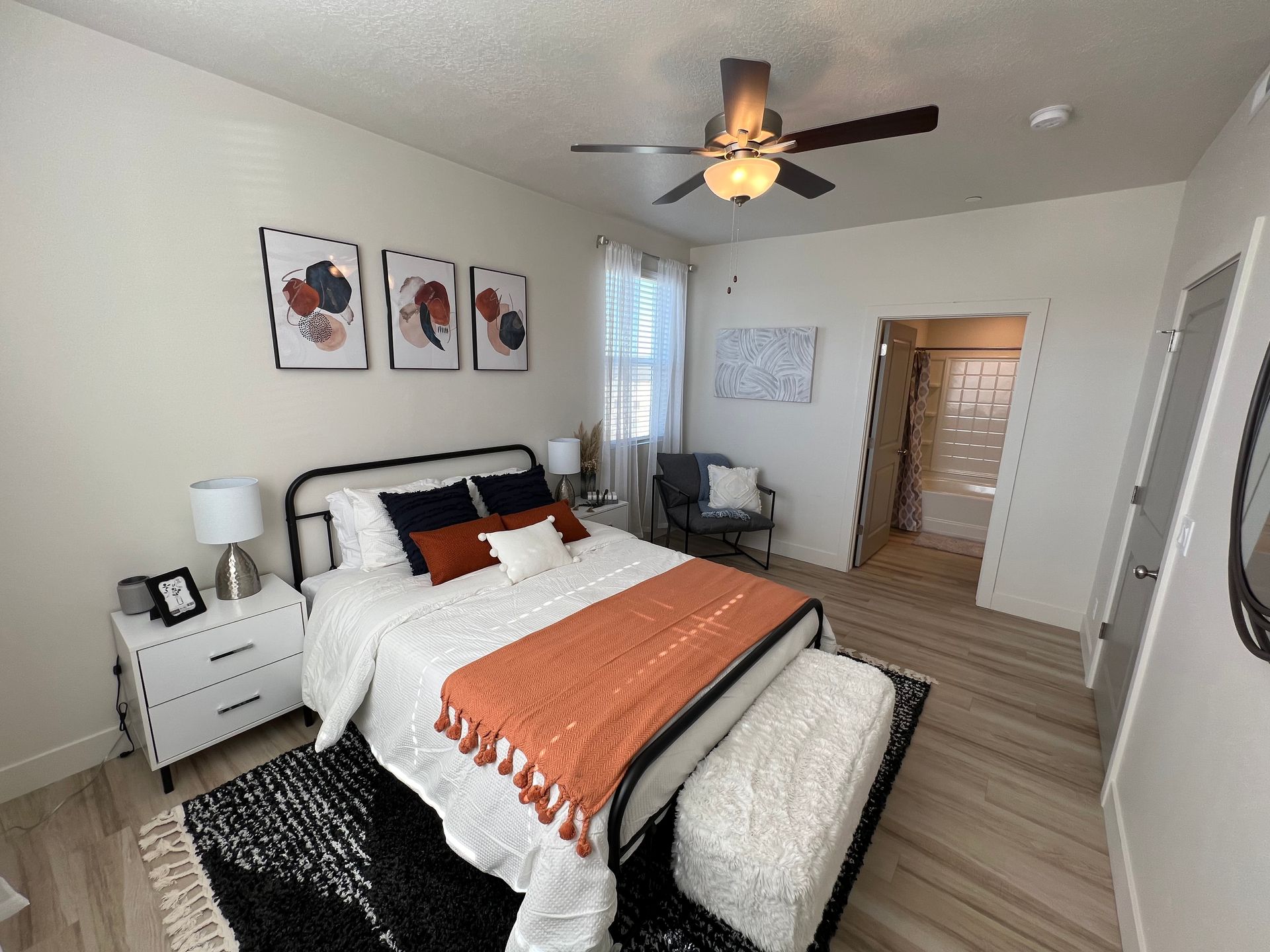 a bedroom with a bed and a ceiling fan