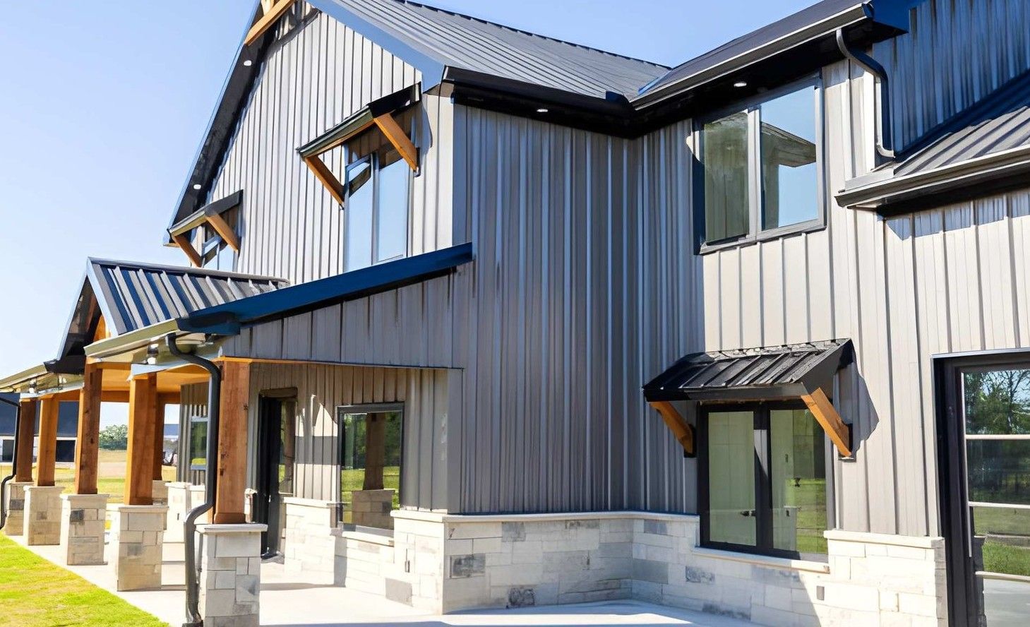 A two-story suburban house with a tan exterior, a stone-accented garage, and a