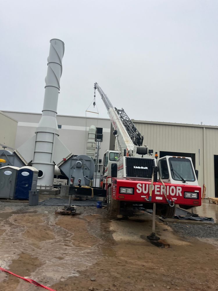 A white mobile crane labeled 