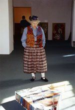 Louse Tester looking at painting on floor