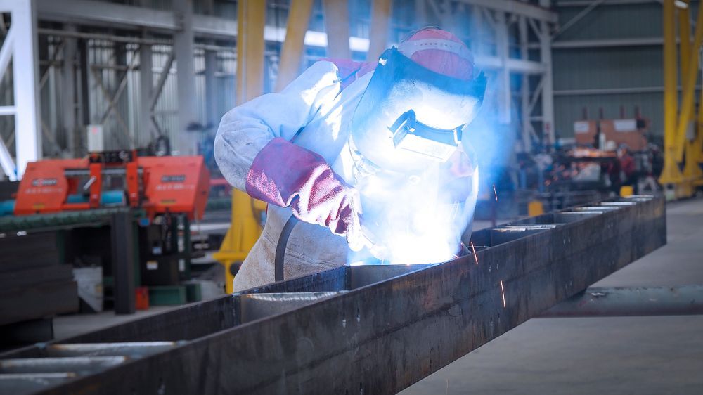 Person Welding Metal Frame — Chris Horton Manufacturing in Bathurst, NSW