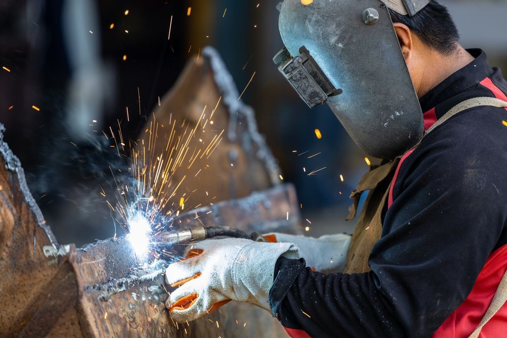 Welder in A Workshop, Sparks Flying, Wearing Protective Gear, Welding Metal — Chris Horton Manufacturing in Bathurst, NSW