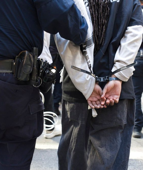 officer arresting young man