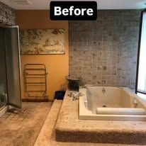 Bathroom before renovation with large jetted tub, beige counters, and tiled walls