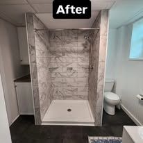 After photo of a finished tiled walk-in shower with a bench and adjacent toilet.