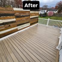 After photo of a weathered wooden deck with a white railing and wood privacy fence