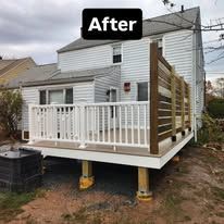 After: small raised deck with white railing and steps added to the back of a house