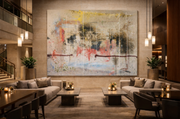 Three people viewing a large wall art display in a modern office meeting room