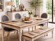 Rustic wooden dining table with benches and chairs in a bright, elegant dining room