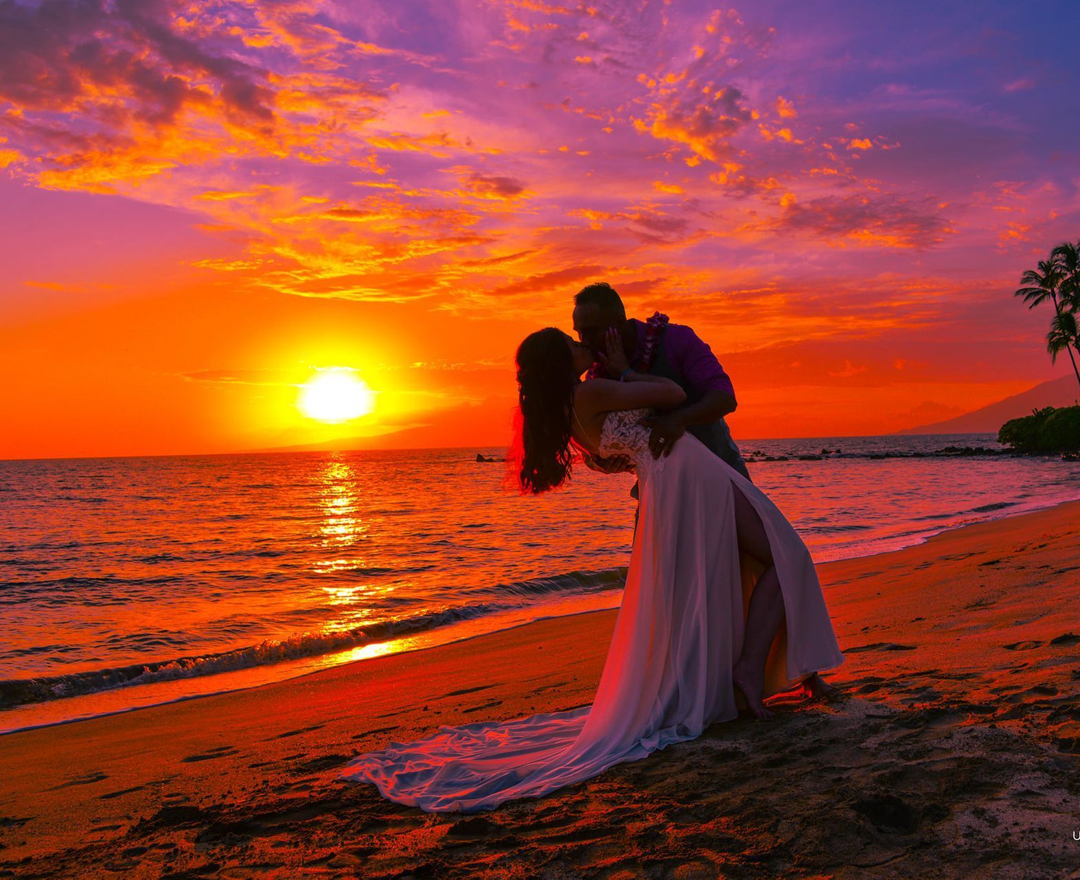 Couple kissing on beach at sunset, vibrant orange and purple sky, ocean waves.