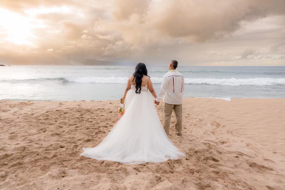 couple looking out at water on beach