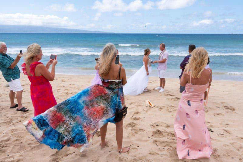 group taking photos on beach