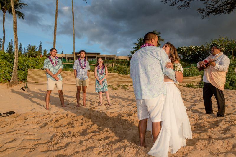 couple on beach with group of people