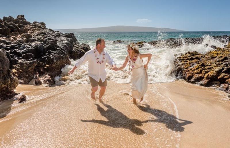 couple holding hands on beach