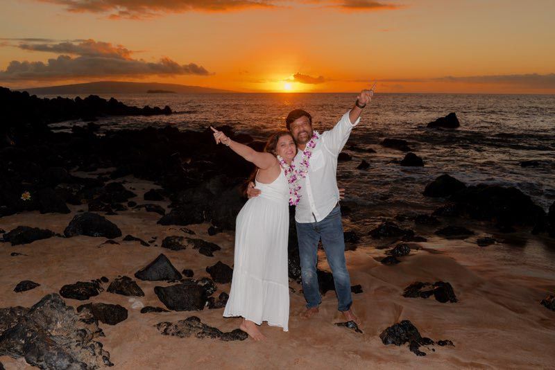 couple celebrating during sunset on beach