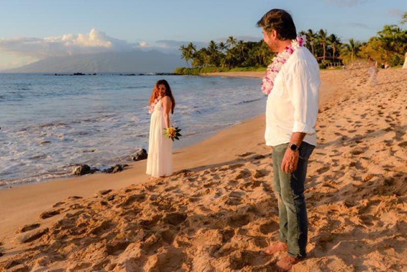 couple on beach looking at ocean