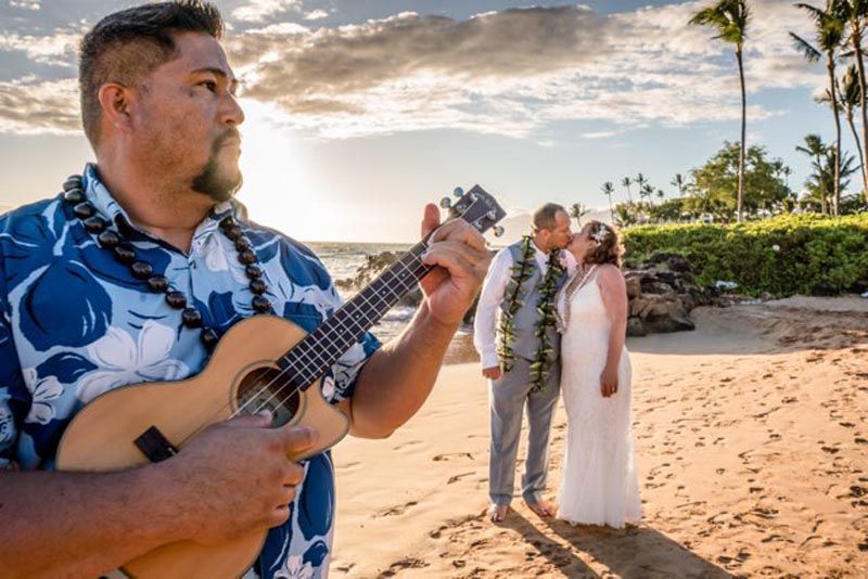 person playing ukelele with couple behind