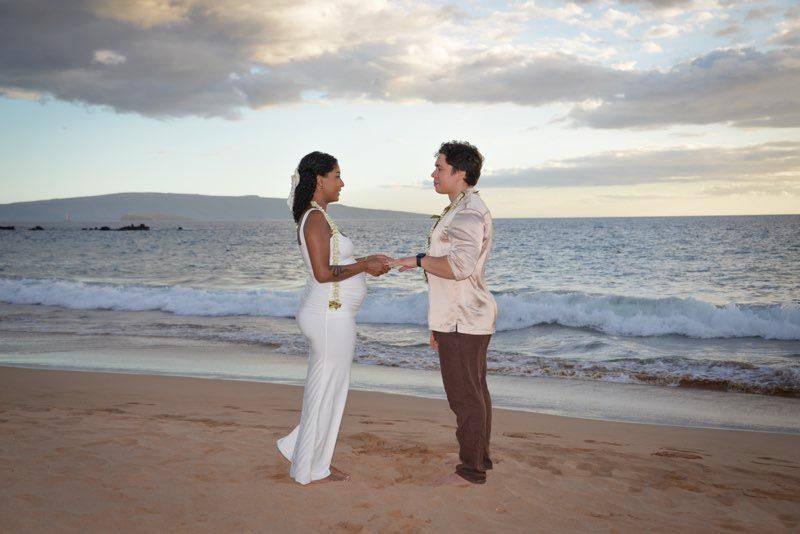 couple holding hands on beach